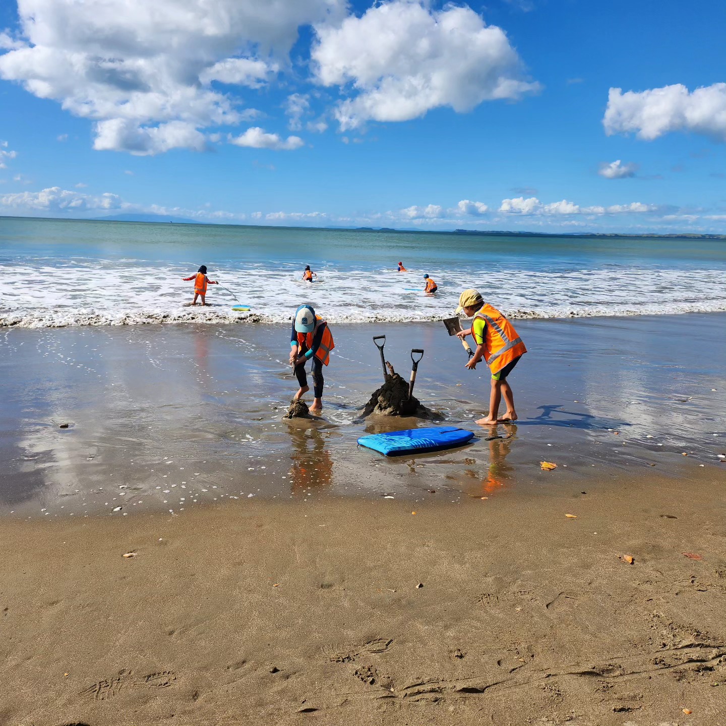 Kids having fun, playing in the water at Long Bay during the school holidays.